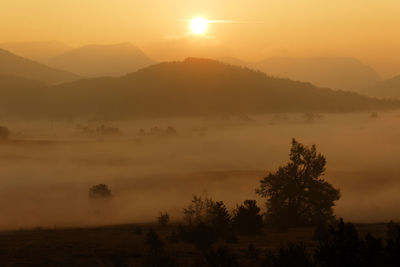 Scenic view of silhouette mountains against sky during sunset