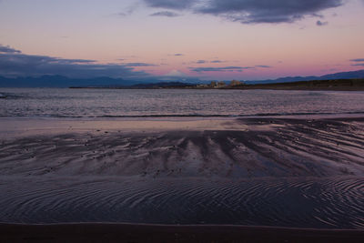 Scenic view of beach against sky during sunset