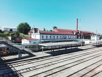 Train at railroad station against clear sky
