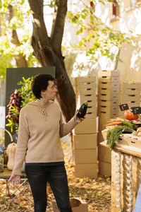 Full length of woman standing by plants