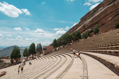 People walking on mountain against sky