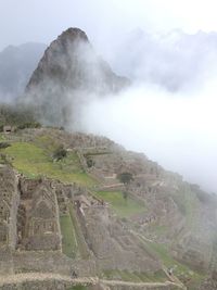 Scenic view of mountains against cloudy sky