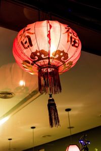 Low angle view of illuminated lanterns hanging on ceiling