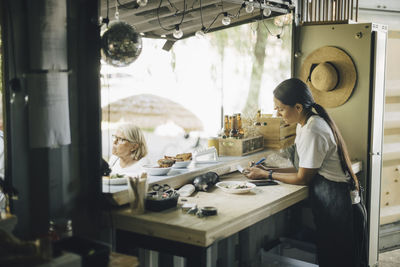 Female entrepreneur working in food truck