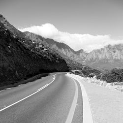 Surface level of empty road against mountain range