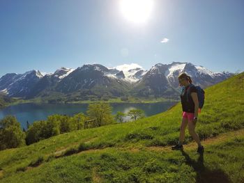 Woman standing on mountain against sky