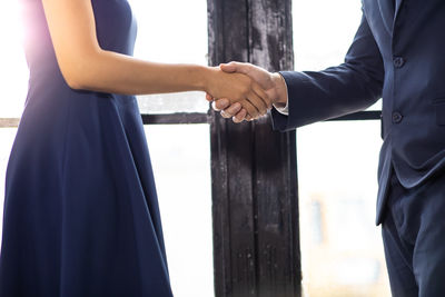 Side view of a man holding hands