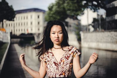 Portrait of beautiful young woman standing outdoors
