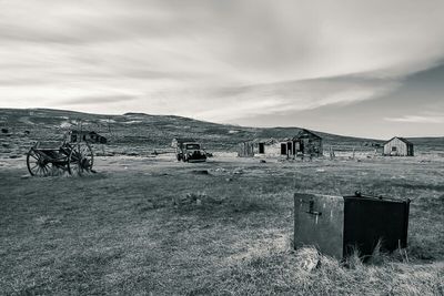 View of field against cloudy sky