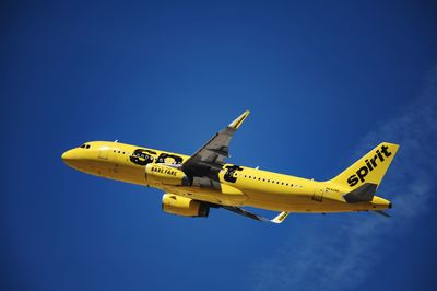 Airplane flying against clear blue sky