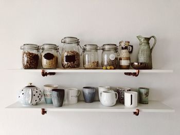 Close-up of jars and cup