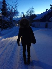 People walking on snow covered landscape