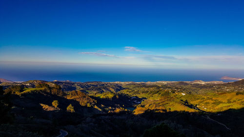 Scenic view of landscape against blue sky