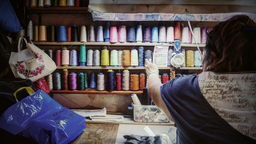 Rear view of woman working at market