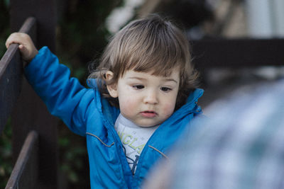 Close-up of baby boy by railing