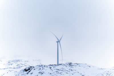 Low angle view of electricity pylon against clear sky