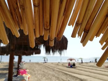 Row of umbrellas on beach against sky