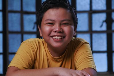 Portrait of a young asian boy smiling.