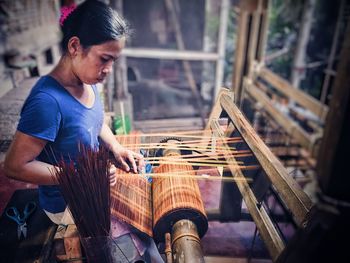 Woman weaving loom