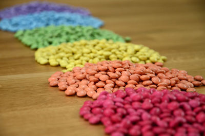 Close-up of colorful candies arranged on wooden table