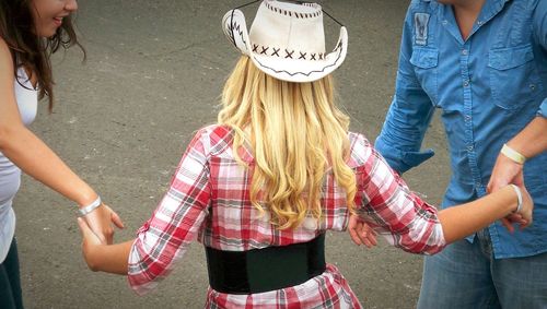 Young woman holding hands in park