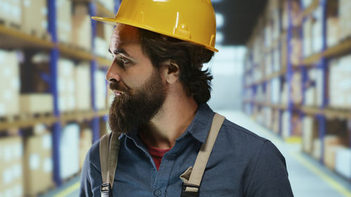 Portrait of young man standing in store