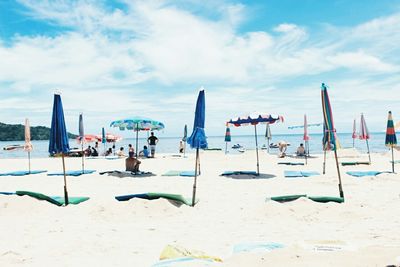 Scenic view of beach against cloudy sky