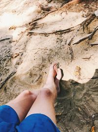 Low section of person standing on land