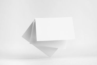 Low angle view of empty paper against white background