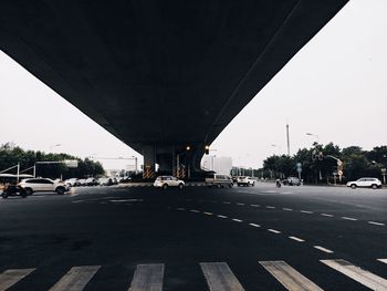 Bridge over road in city against sky