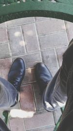 Low section of woman standing on tiled floor