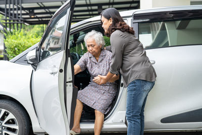 Side view of couple sitting in car