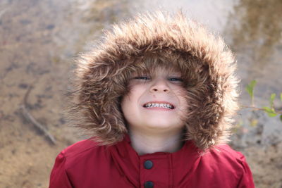 Portrait of smiling boy in fur coat