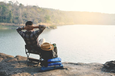 Man sitting by lake