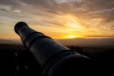 View of vintage cannon during dramatic sunrise in cape town