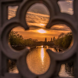 View of bridge over river during sunset