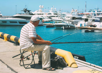 Man fishing in harbor