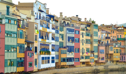 Multi colored houses against sky in city