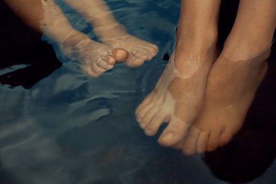 Feet relaxing in the water together barefoot