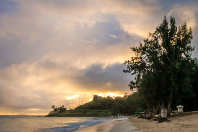 Scenic view of beach against sky during sunset