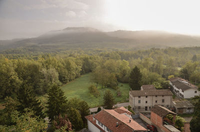 High angle view of trees and buildings against sky