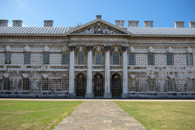 Facade of historic building against sky in city