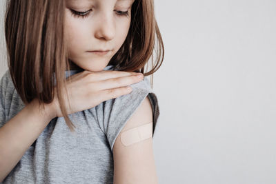 The girl was vaccinated in her arm, a plaster on her arm