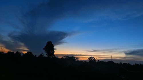 Silhouette trees against sky during sunset