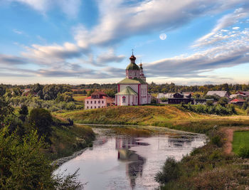 River amidst buildings against sky