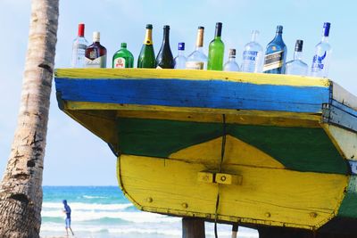 Close-up of bottles against sea