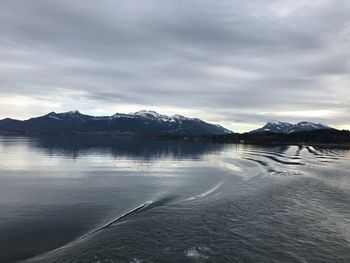 Scenic view of frozen lake against cloudy sky