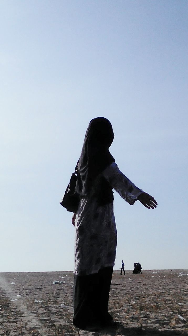 clear sky, sea, water, copy space, horizon over water, statue, sculpture, beach, human representation, silhouette, standing, nature, art and craft, full length, tranquility, leisure activity, art, tranquil scene, men