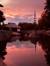 Reflection of building in lake during sunset