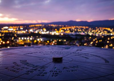 Close-up of illuminated city during sunset